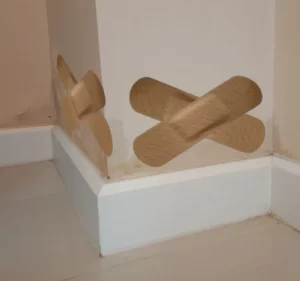 Sticking plaster on damp wall